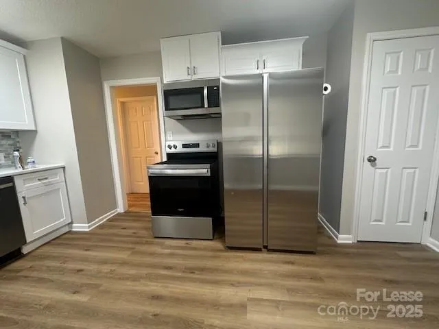 a kitchen with a refrigerator and a sink