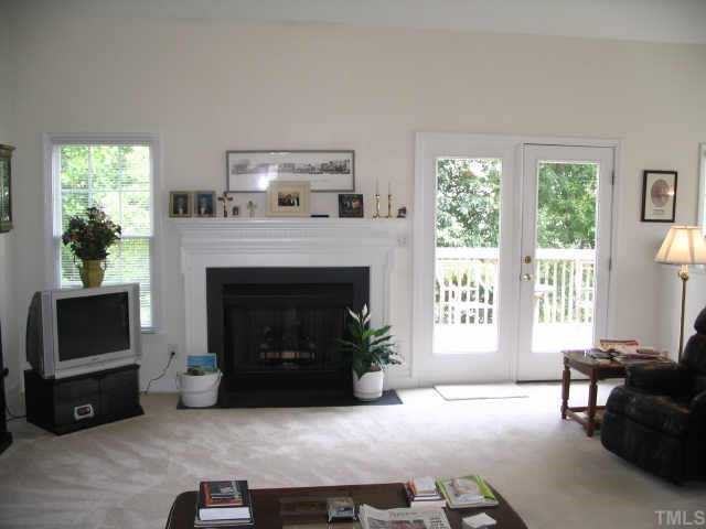 8633 Harps Mill Road Raleigh, NC 27615 - Photo 3 of 10 a living room with furniture and a fireplace