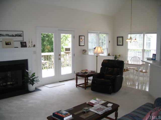 8633 Harps Mill Road Raleigh, NC 27615 - Photo 4 of 10 a living room with furniture and a fireplace
