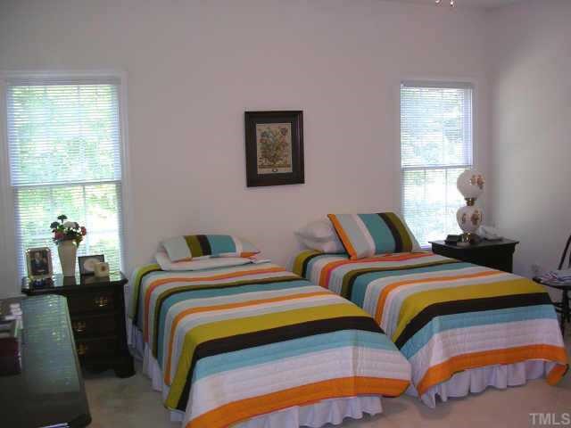 8633 Harps Mill Road Raleigh, NC 27615 - Photo 7 of 10 a bedroom with two beds and a window