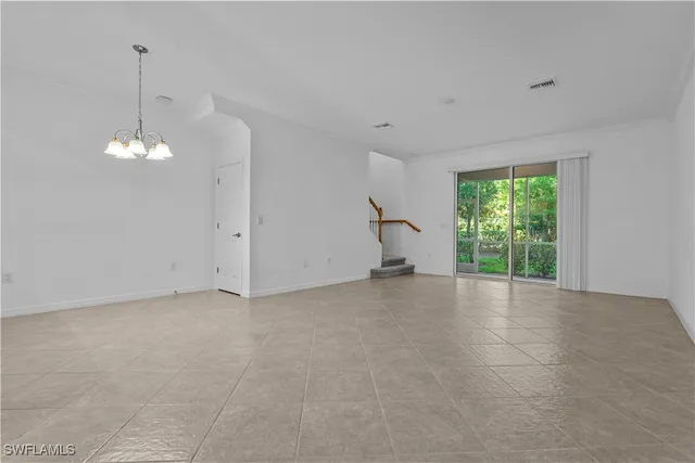 a view of a livingroom with a ceiling fan and window