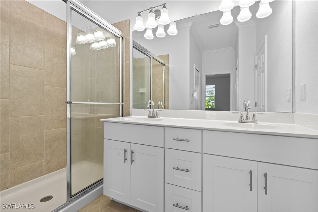 12568 Westhaven Way Fort Myers, FL 33913 - Photo 20 of 26 a bathroom with double vanity sink a vanity and mirror