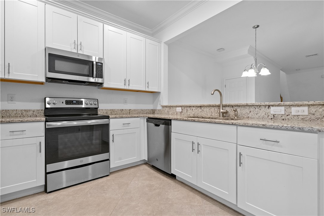 12568 Westhaven Way Fort Myers, FL 33913 - Photo 5 of 26 a kitchen with granite countertop white cabinets white stainless steel appliances and a sink
