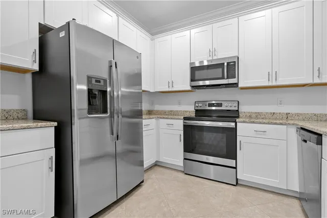 a kitchen with stainless steel appliances white cabinets and a sink