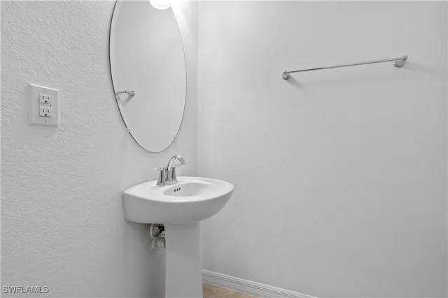 a bathroom with a sink a mirror and a shower