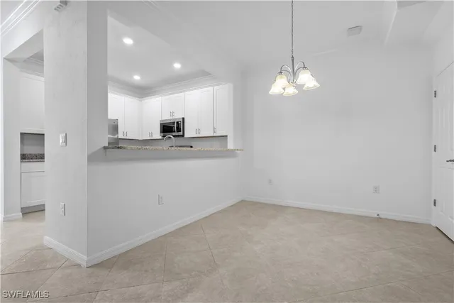 a view of a kitchen with electric appliances