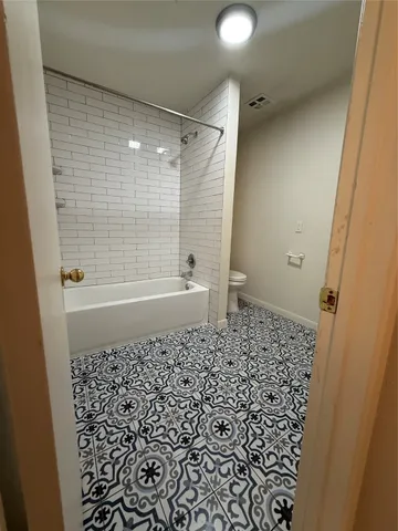 a bathroom with a shower and a toilet