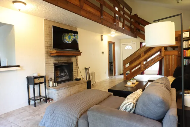 a living room with furniture and a fireplace