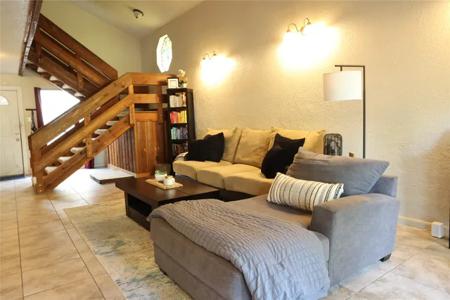 a bedroom with furniture and a mirror