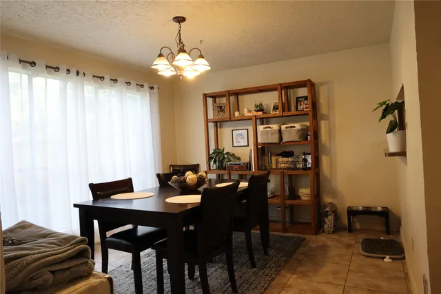 a dining room with furniture and chandelier