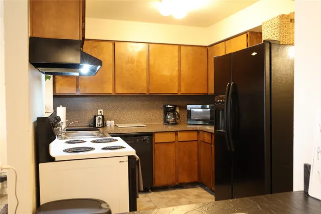 a kitchen with a sink a refrigerator and cabinets
