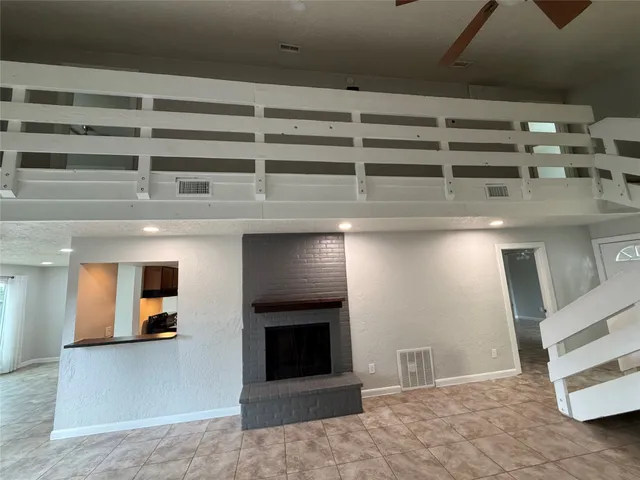 a view of a livingroom with an empty space and a fireplace