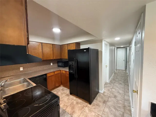 a kitchen with a refrigerator and a sink