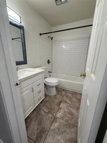 a bathroom with a sink a toilet a mirror and shower