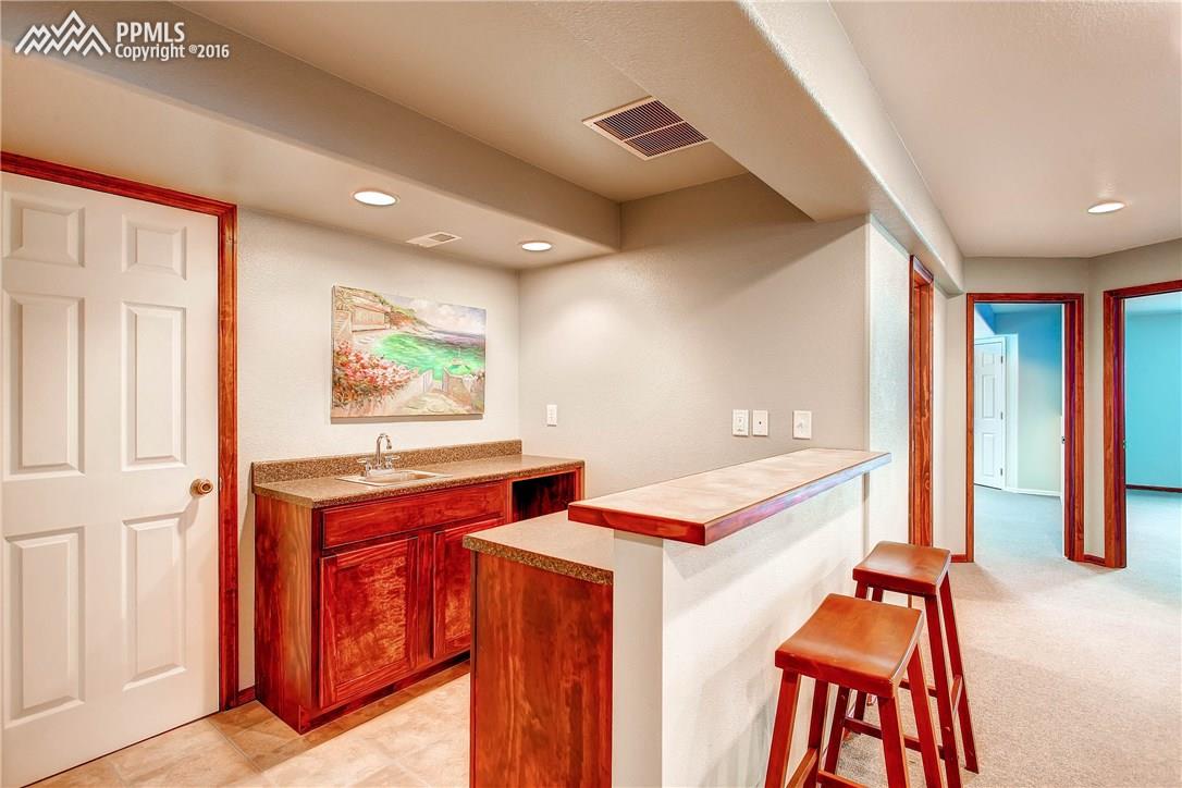 12330 Motley Road Peyton, CO 80831 - Photo 19 of 27 Extra storage space plus this great wet bar off the Rec Room in the basement