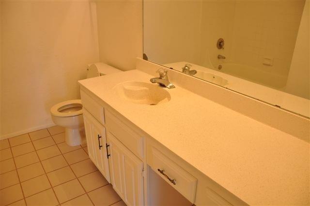 5630 Spring Valley Road, Unit 13C Dallas, TX 75254 - Photo 13 of 16 a bathroom with a sink and a toilet