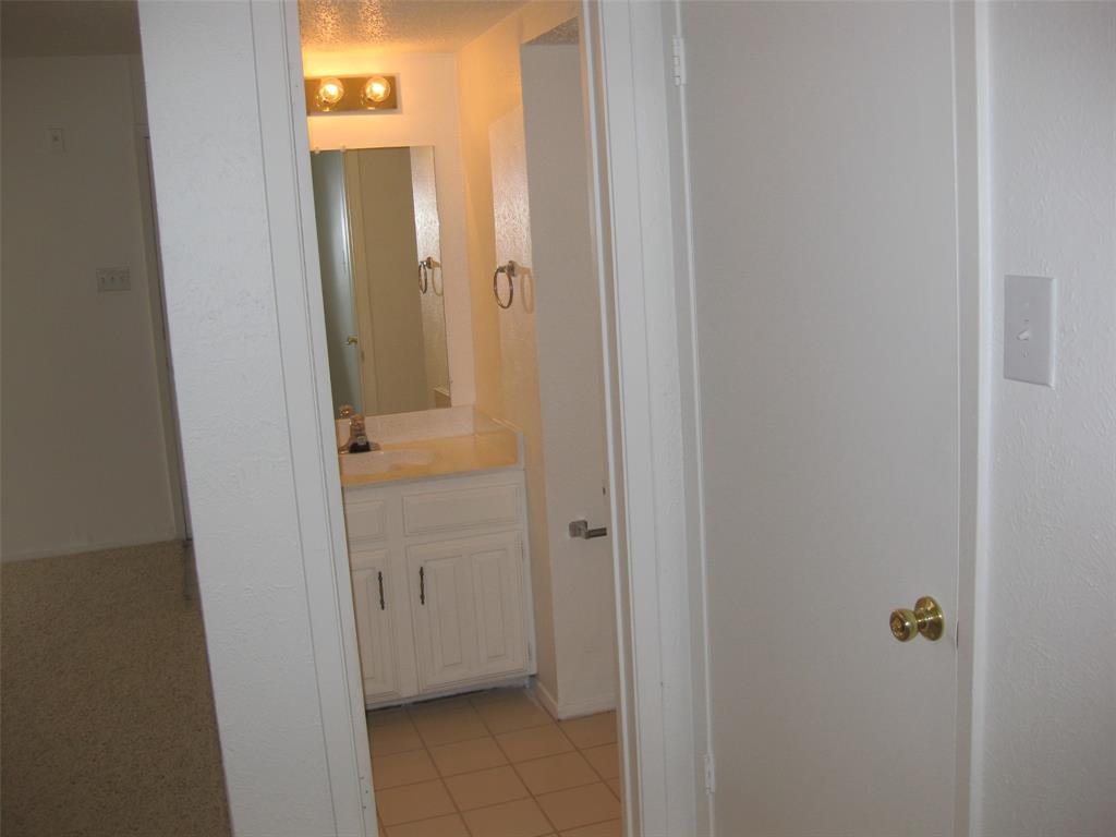 5630 Spring Valley Road, Unit 13C Dallas, TX 75254 - Photo 16 of 16 a view of a bathroom from a corridor