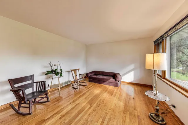 a bedroom with furniture and a wooden floor