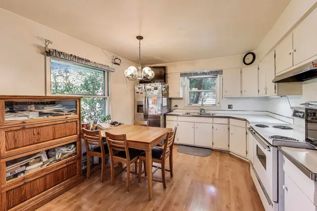 a kitchen with a table chairs stove and cabinets
