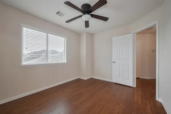 a view of a livingroom with a hardwood floor and a ceiling fan