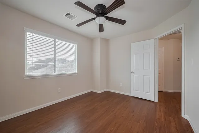 a view of a livingroom with a hardwood floor and a ceiling fan