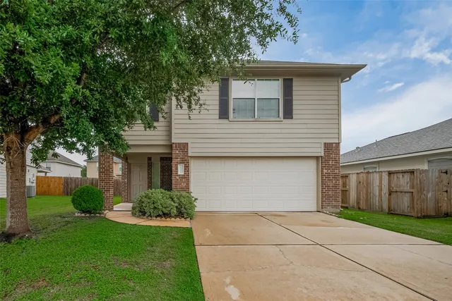 a front view of house with yard and trees