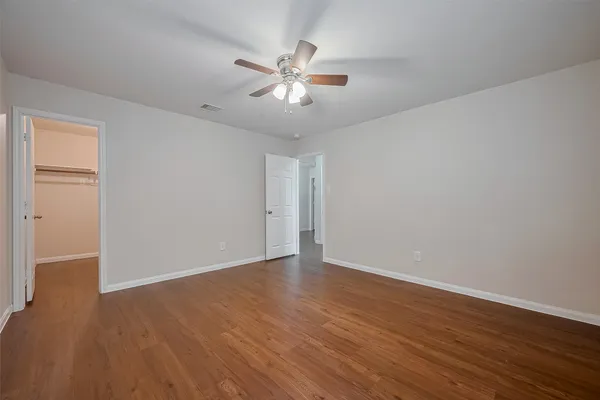 a view of an empty room with wooden floor