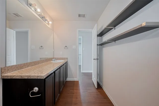 a kitchen with a wooden floor and a sink