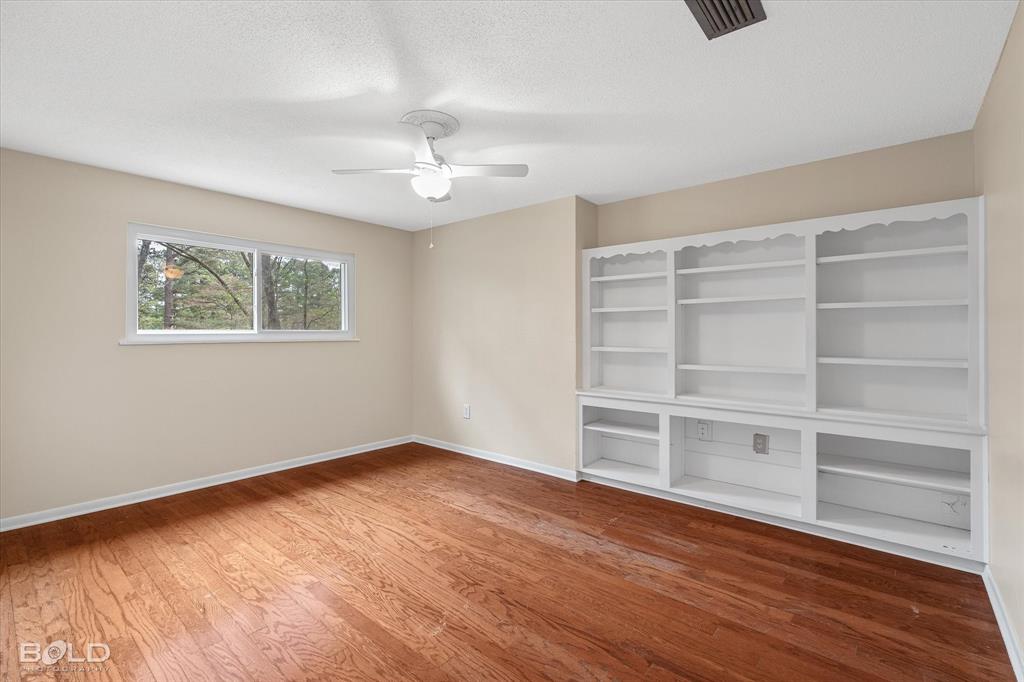 15 Lee Lane Haughton, LA 71037 - Photo 18 of 39 a view of an empty room with a window and wooden floor
