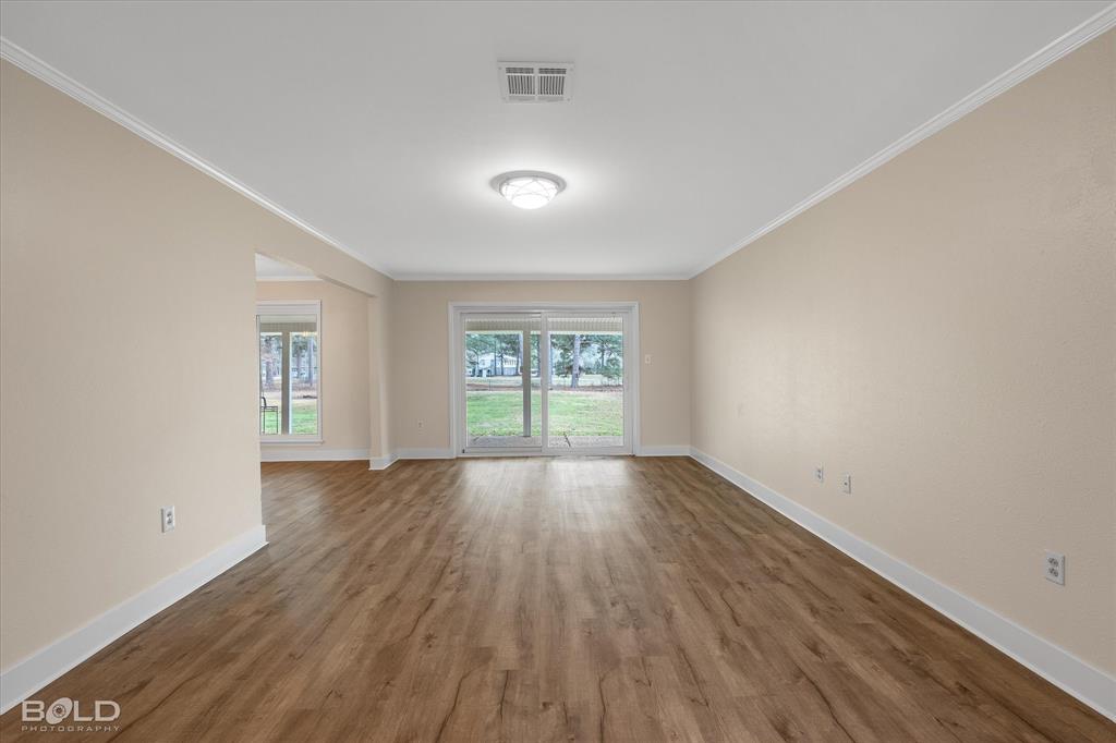 15 Lee Lane Haughton, LA 71037 - Photo 4 of 39 an empty room with wooden floor and windows