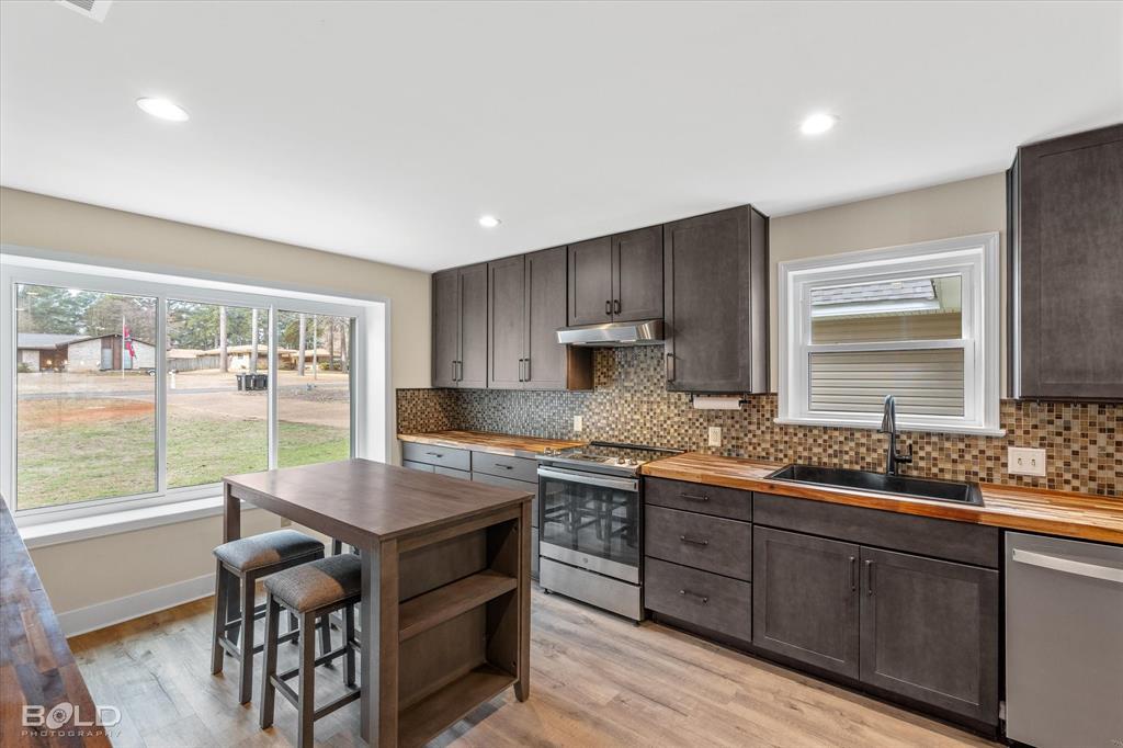 15 Lee Lane Haughton, LA 71037 - Photo 7 of 39 a kitchen with granite countertop a sink stove and cabinets