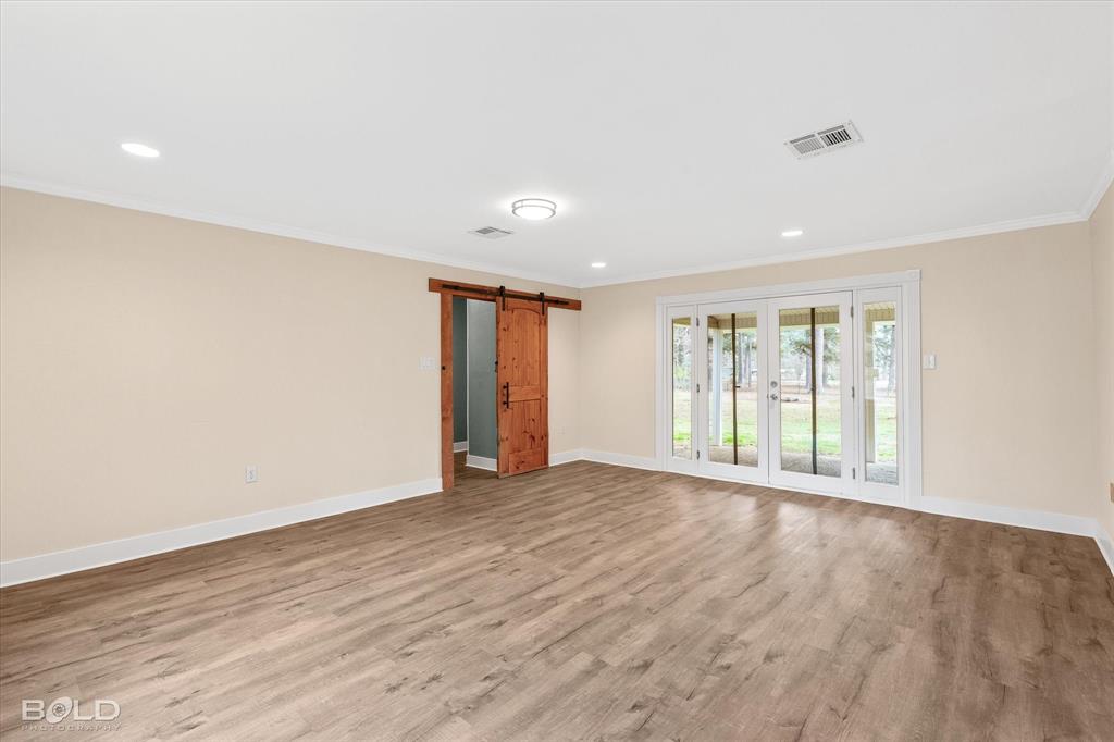 15 Lee Lane Haughton, LA 71037 - Photo 9 of 39 a view of an empty room with wooden floor and a window