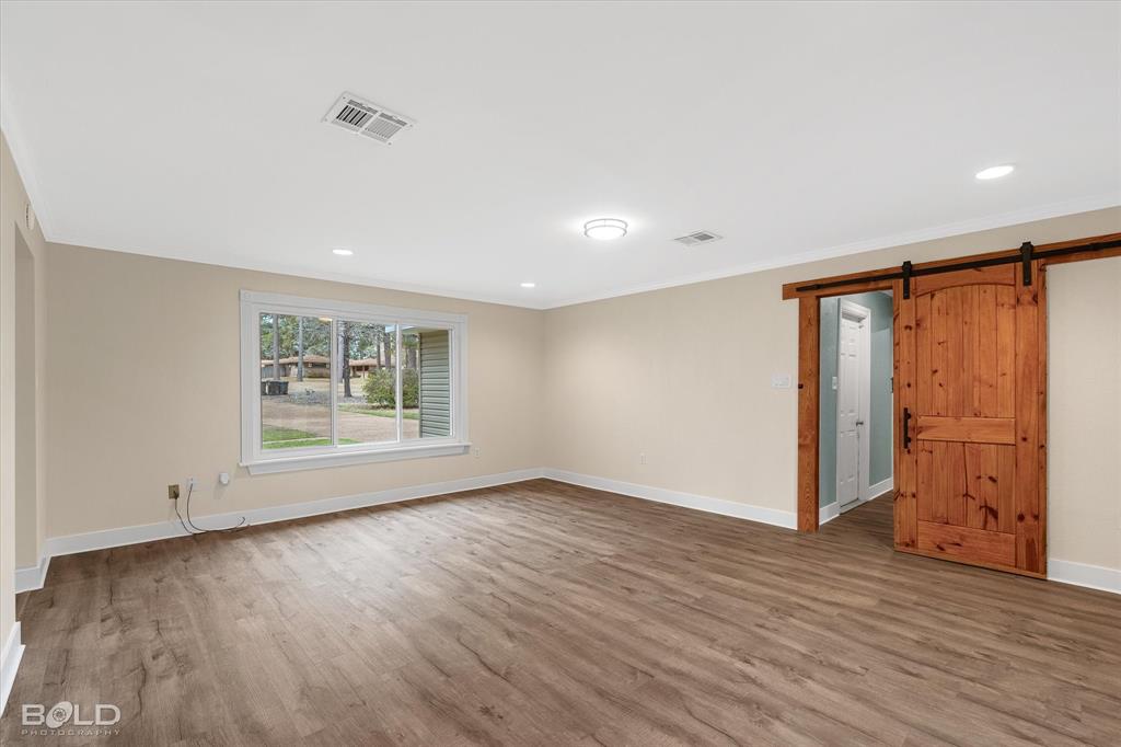15 Lee Lane Haughton, LA 71037 - Photo 10 of 39 a view of an empty room with wooden floor and a window