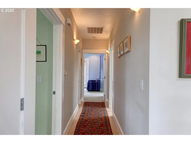 a view of a hallway with wooden shelves