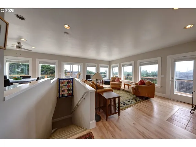 a view of a hallway with wooden floor and entryway
