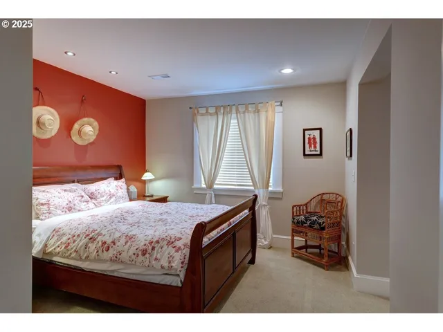 a bed sitting in a bedroom next to a window