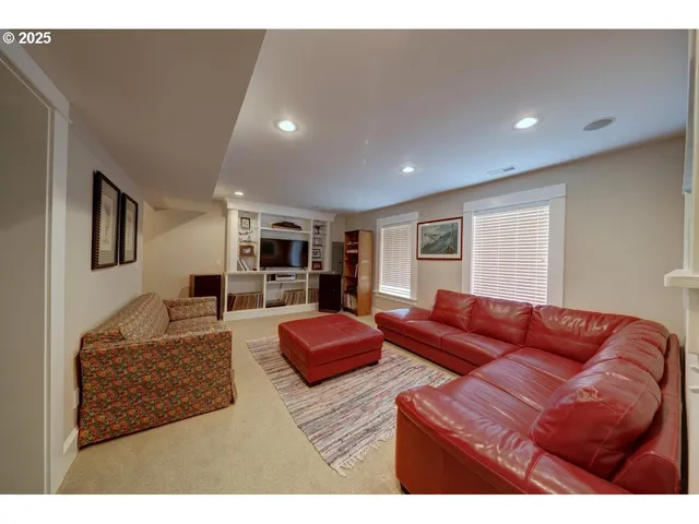 a spacious bedroom with a bed and dresser