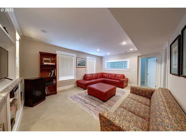 a living room with furniture a flat screen tv and a window