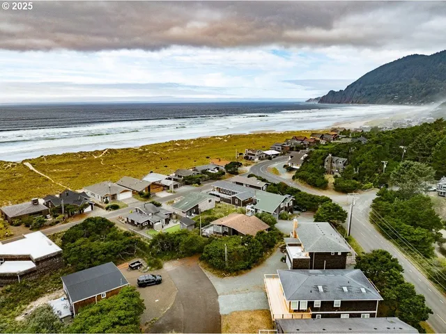 an aerial view of a house with garden space and ocean view