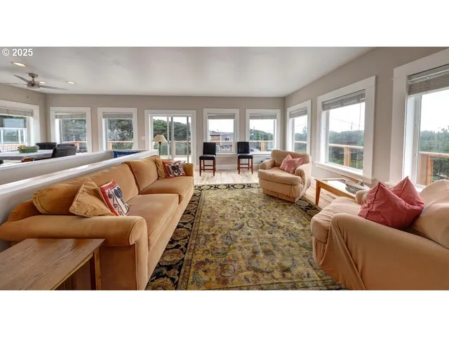 a living room with furniture and large windows