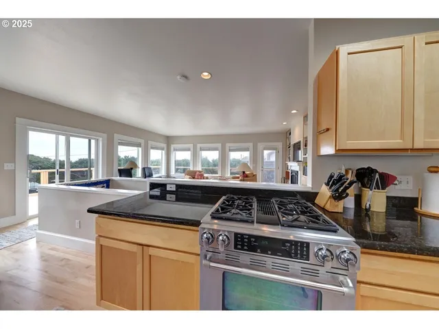 a kitchen with a stove and white cabinets