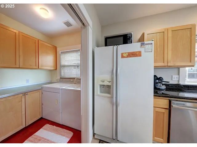 a kitchen with a refrigerator and cabinets