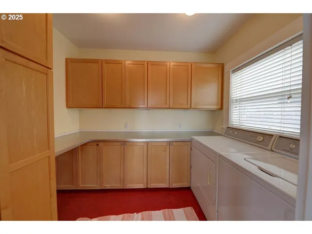 a kitchen with a sink a window and cabinets