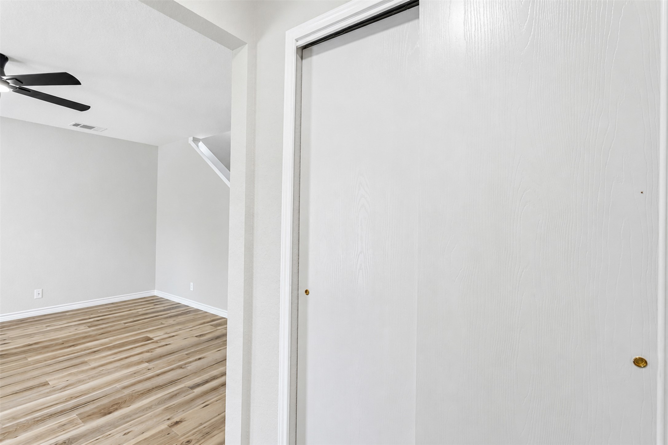 4523 Secure Lane Austin, TX 78725 - Photo 4 of 40 A well-lit interior space features sleek wood flooring and a convenient sliding closet door.