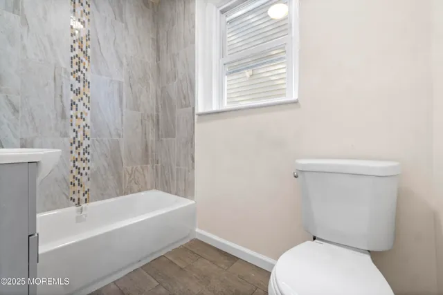 a bathroom with a toilet and a bathtub