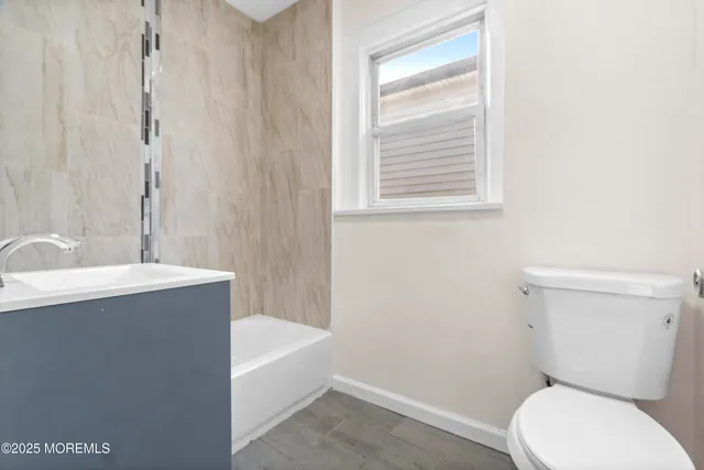 a bathroom with a toilet a sink and bathtub