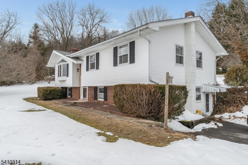 252 Mountain View Road West Asbury, NJ 08802 - Photo 19 of 28 a view of a white house with a yard covered in snow