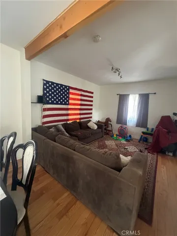 a bedroom with a bed and a refrigerator