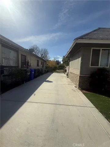 a pathway of house with yard
