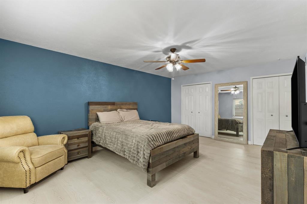 2113 Victoria Road Carrollton, TX 75007 - Photo 11 of 19 a living room with a bed furniture and a ceiling fan